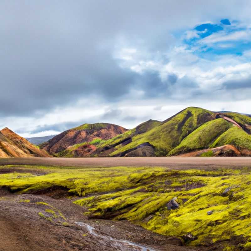 Un aventurero solitario recorre el sendero de Laugavegur, Islandia, durante una aventura otoñal de 4 días, rodeado de vibrantes tonos dorados y rojizos que iluminan el impresionante paisaje.